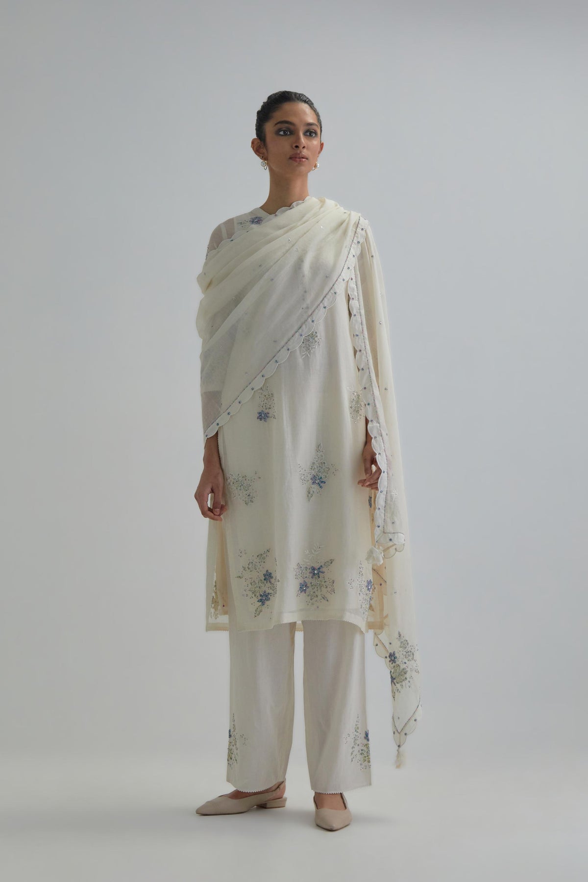 Off white straight short kurta set with all-over blue & beige hand block printed appliqué motifs, highlighted with sequins and multi coloured beads.