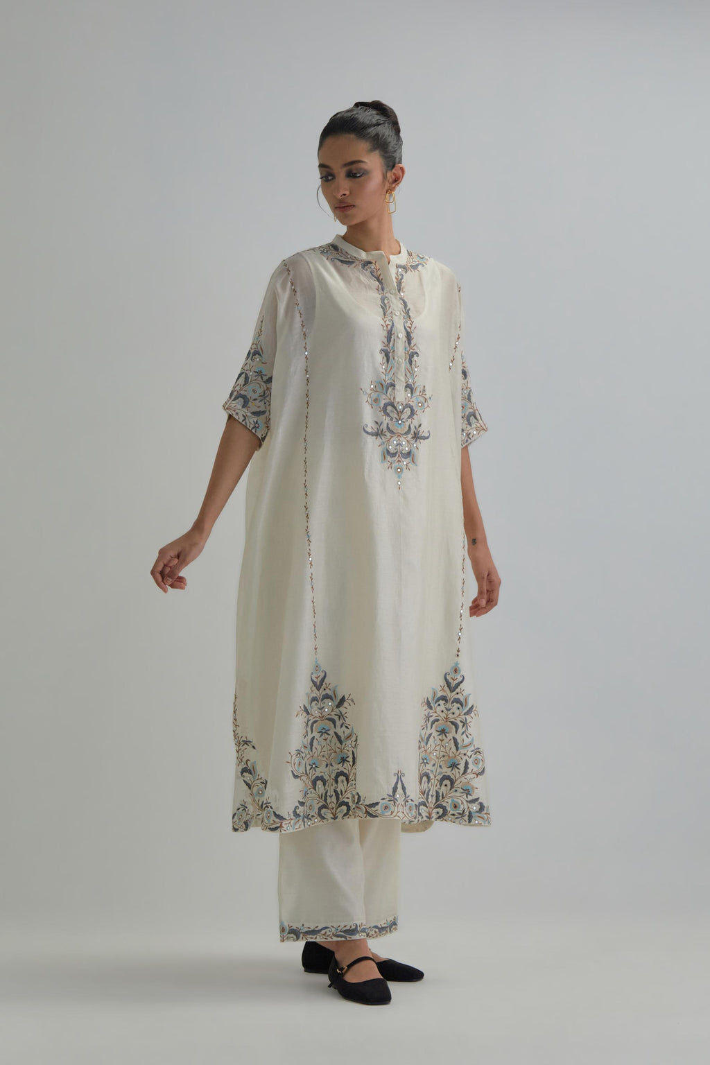 Off white Silk Chanderi easy fit kaftan with earthy coloured thread Aari embroidery, highlighted with silver sequins work, paired with Off white silk Chanderi straight pants with earthy coloured Aari work at hem.