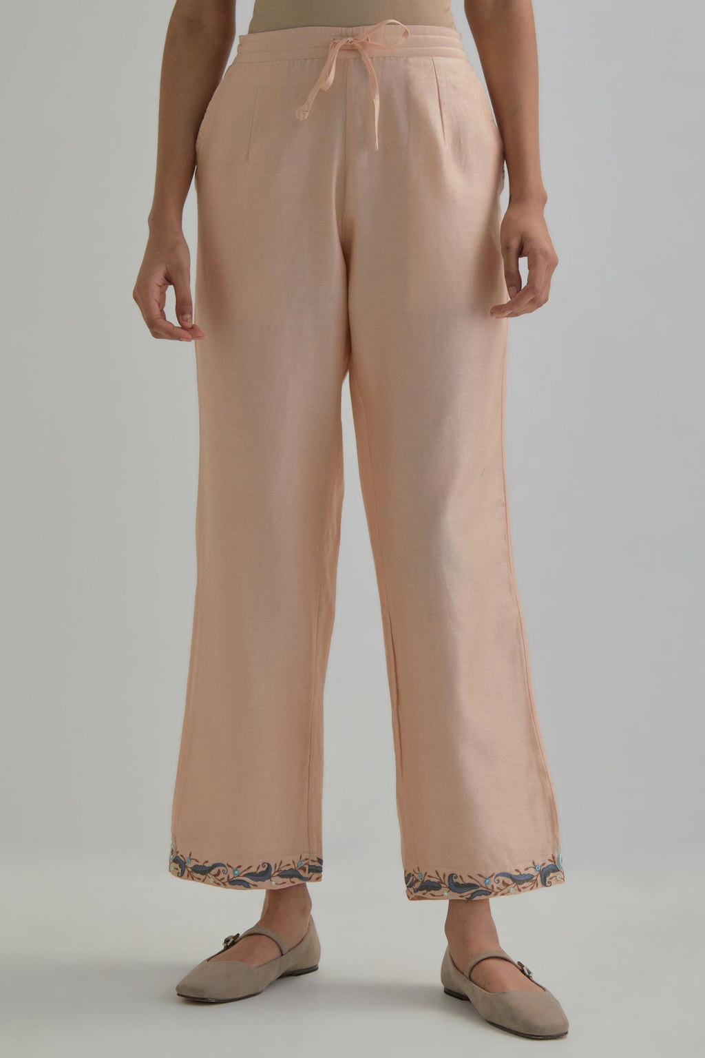 Pink silk Chanderi straight pants with earthy coloured Aari work at hem.