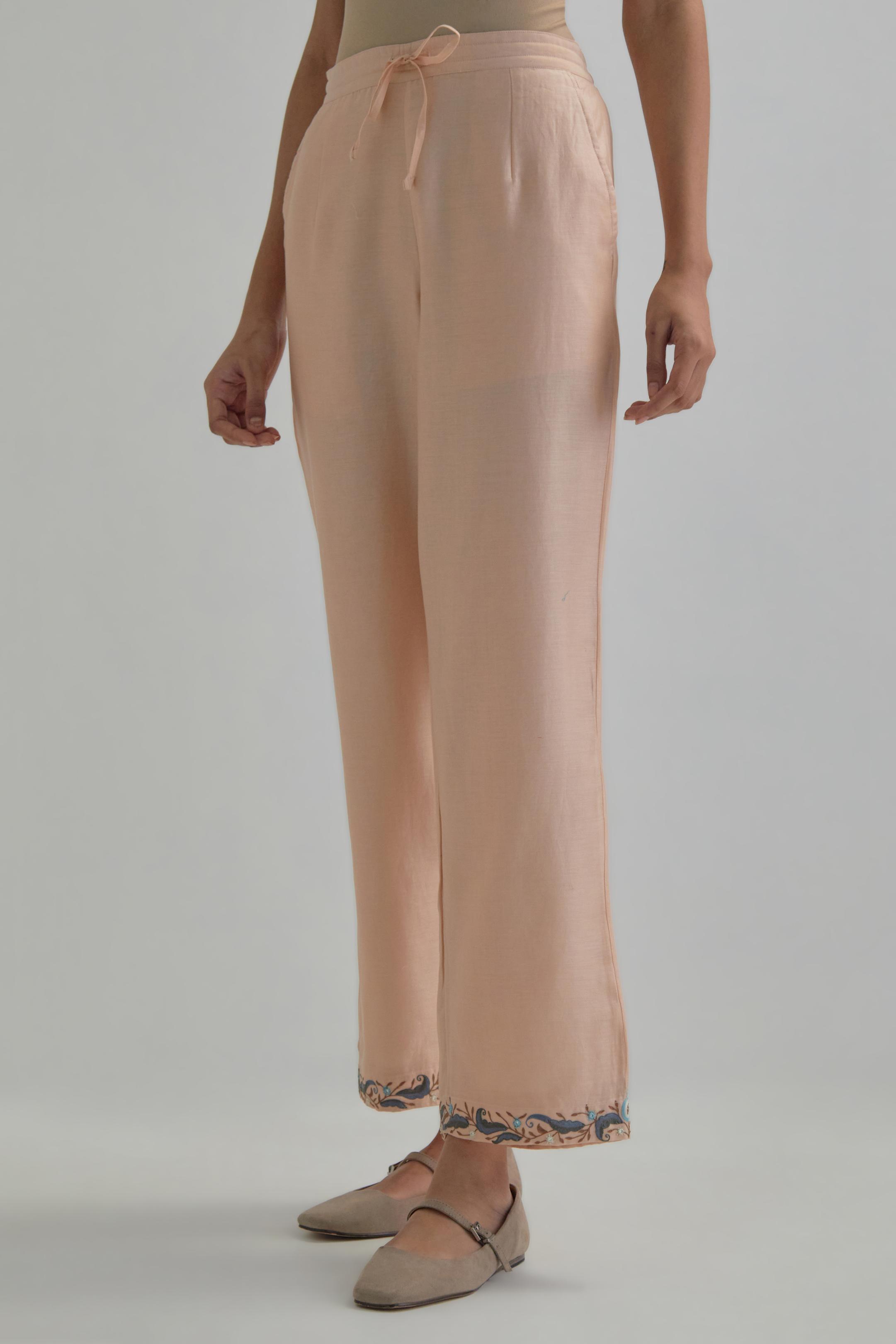 Pink silk Chanderi straight pants with earthy coloured Aari work at hem.