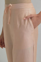 Pink silk Chanderi straight pants with earthy coloured Aari work at hem.