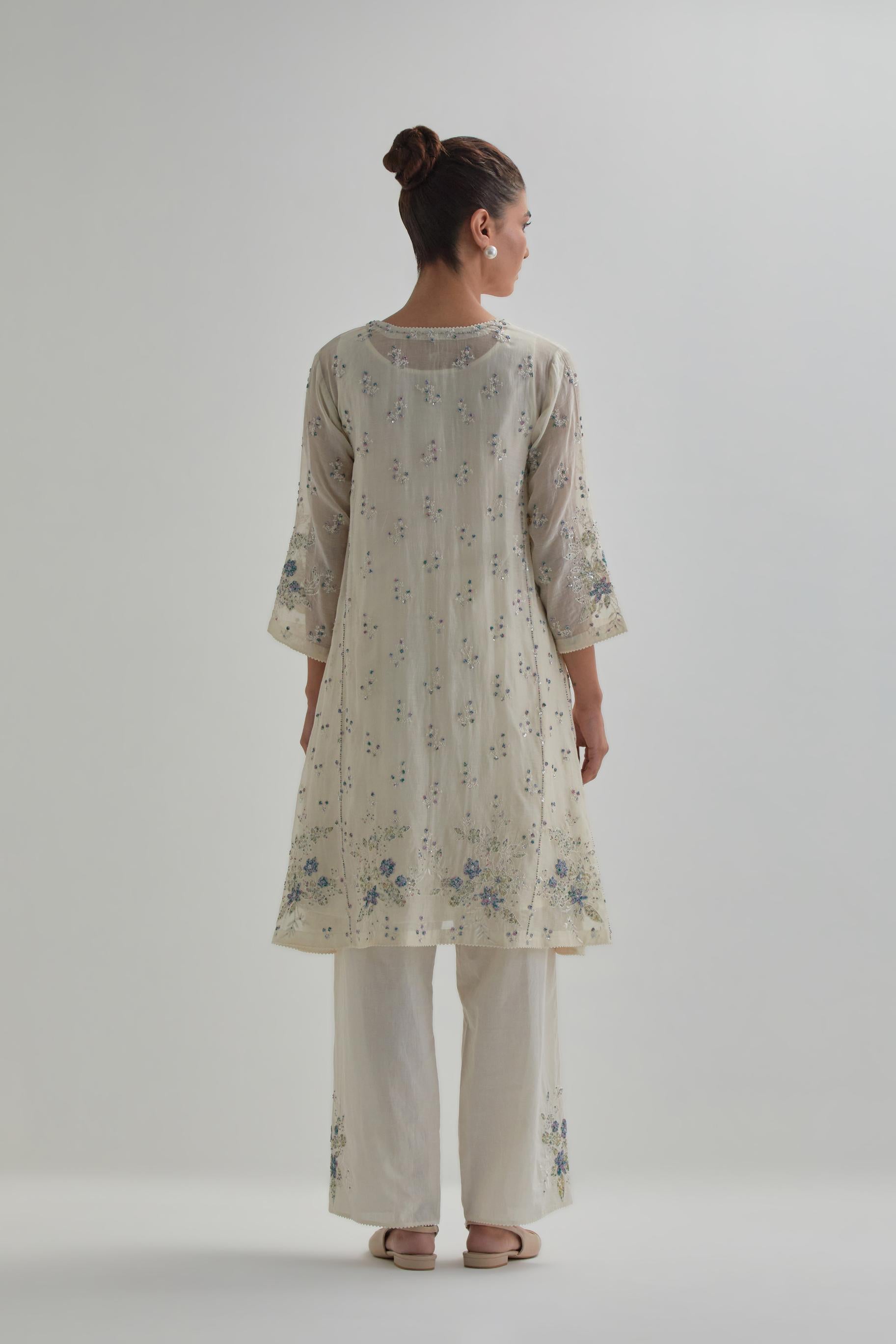 Off white cotton Chanderi short kalidar kurta set with all-over blue & beige hand block printed appliqué flowers, highlighted with sequins and multi coloured beads.