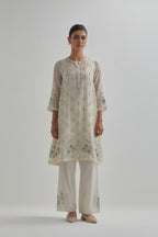 Off white cotton Chanderi short kalidar kurta set with all-over blue & beige hand block printed appliqué flowers, highlighted with sequins and multi coloured beads.