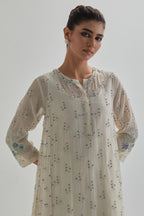 Off white cotton Chanderi short kalidar kurta set with all-over blue & beige hand block printed appliqué flowers, highlighted with sequins and multi coloured beads.