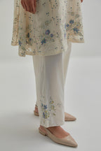 Off white cotton Chanderi short kalidar kurta set with all-over blue & beige hand block printed appliqué flowers, highlighted with sequins and multi coloured beads.
