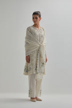 Off white cotton Chanderi short kalidar kurta set with all-over blue & beige hand block printed appliqué flowers, highlighted with sequins and multi coloured beads.