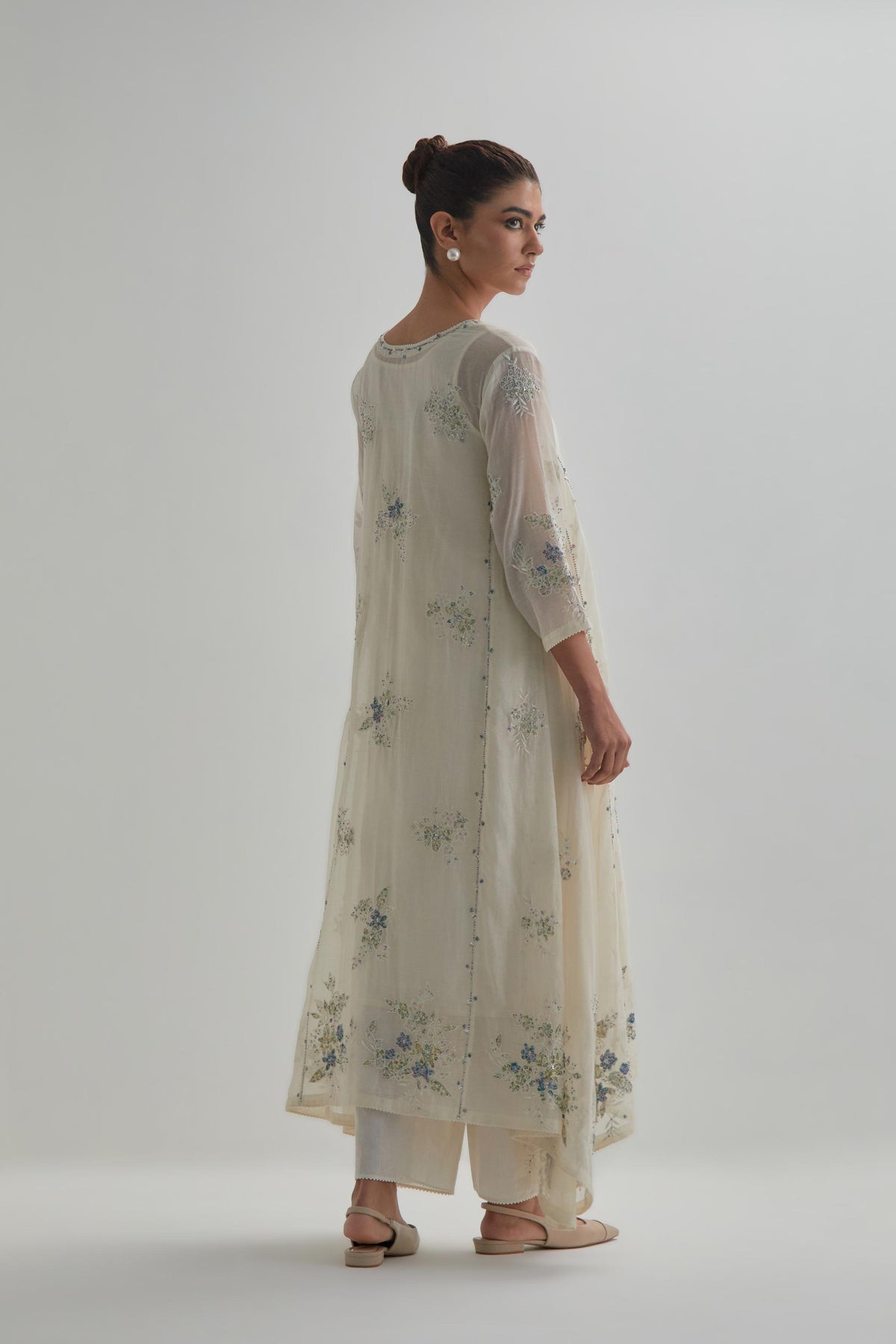 Off-white cotton Chanderi kurta set with asymmetric hem and all-over blue & beige hand block printed appliqué flowers.