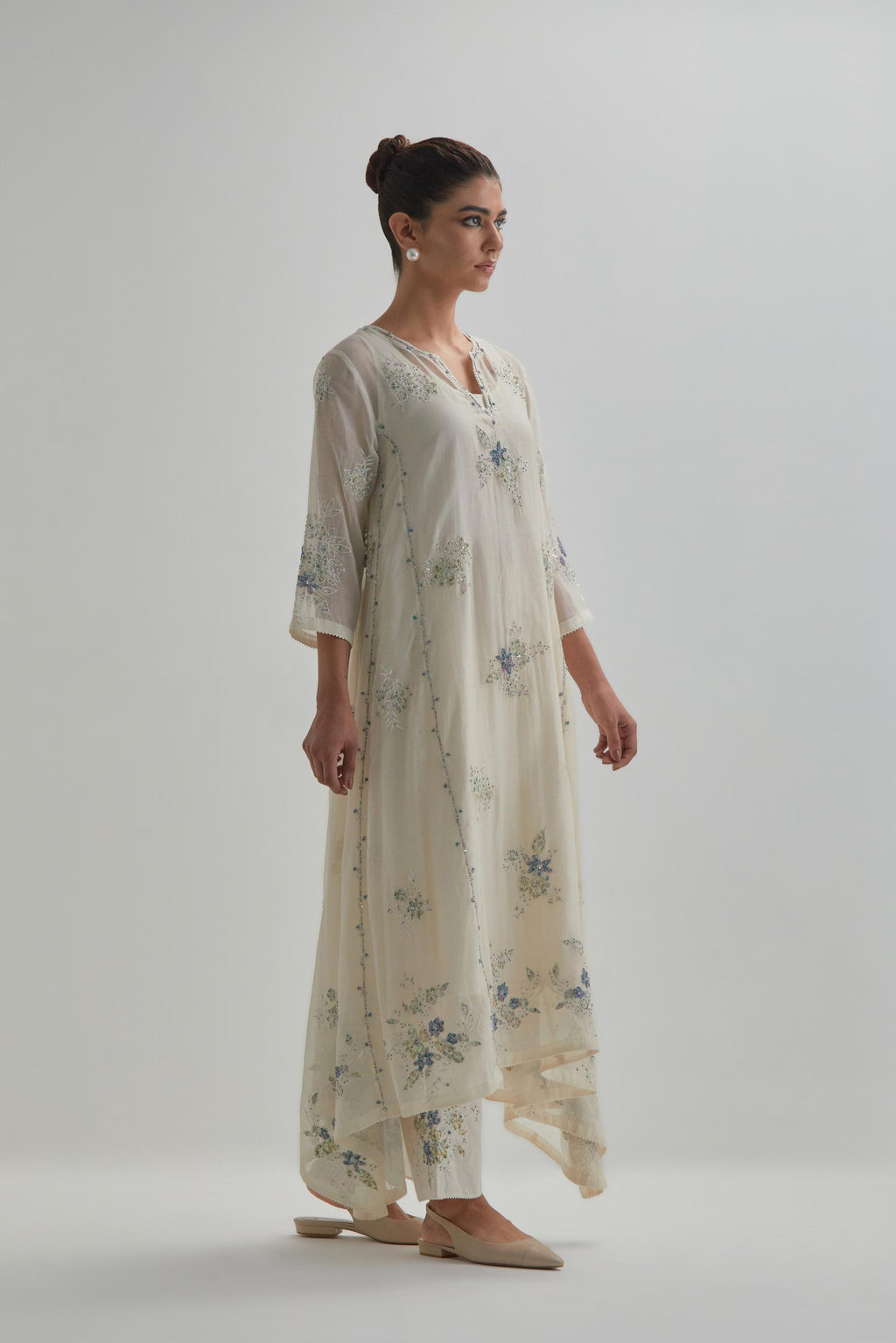 Off-white cotton Chanderi kurta set with asymmetric hem and all-over blue & beige hand block printed appliqué flowers.