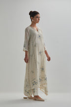 Off-white cotton Chanderi kurta set with asymmetric hem and all-over blue & beige hand block printed appliqué flowers.
