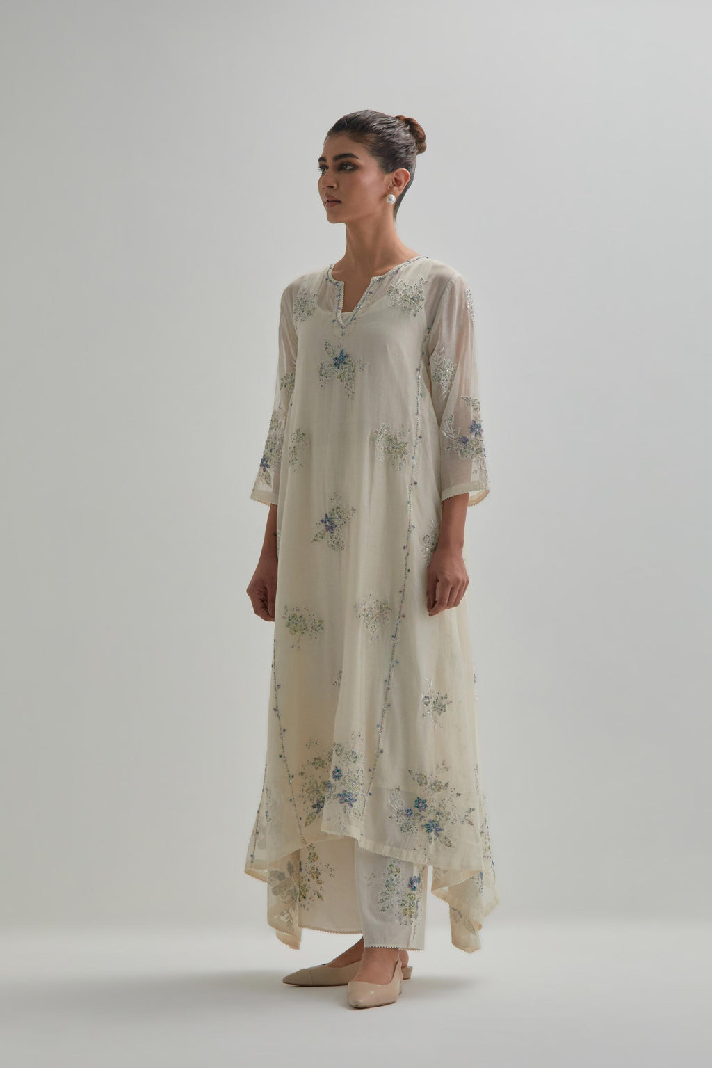 Off-white cotton Chanderi kurta set with asymmetric hem and all-over blue & beige hand block printed appliqué flowers.