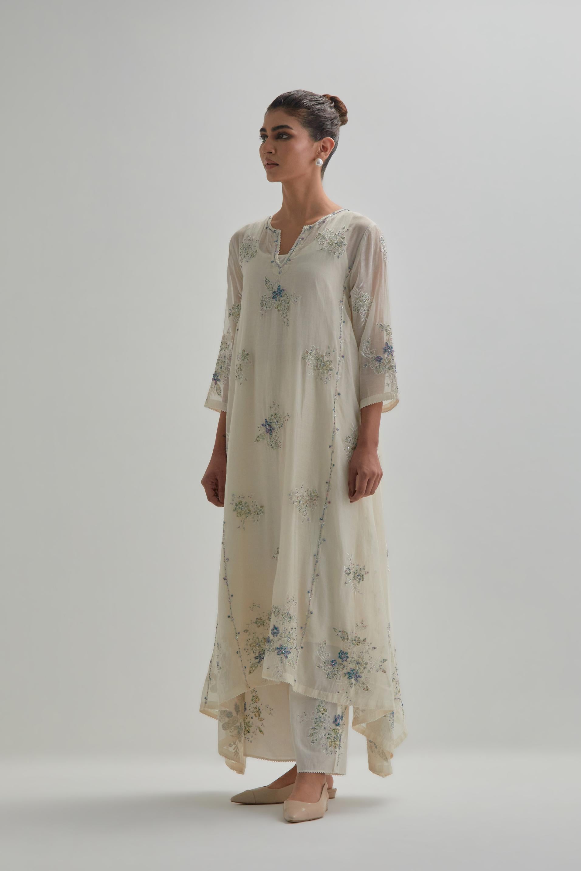 Off-white cotton Chanderi kurta set with asymmetric hem and all-over blue & beige hand block printed appliqué flowers.