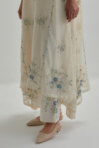 Off-white cotton Chanderi kurta set with asymmetric hem and all-over blue & beige hand block printed appliqué flowers.