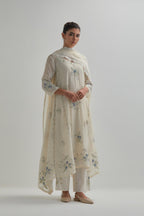 Off-white cotton Chanderi kurta set with asymmetric hem and all-over blue & beige hand block printed appliqué flowers.
