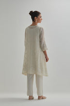Off white cotton Chanderi short kalidar kurta set with all-over appliqué flowers, highlighted with sequins and beads.