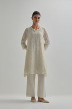 Off white cotton Chanderi short kalidar kurta set with all-over appliqué flowers, highlighted with sequins and beads.