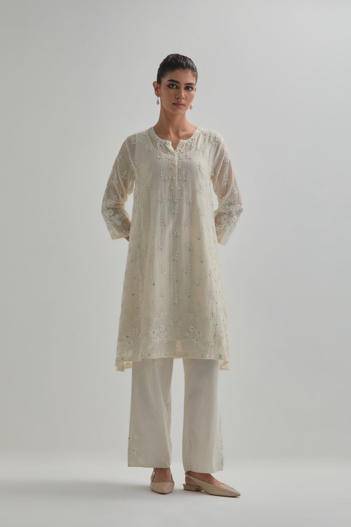 Off white cotton Chanderi short kalidar kurta set with all-over appliqué flowers, highlighted with sequins and beads.