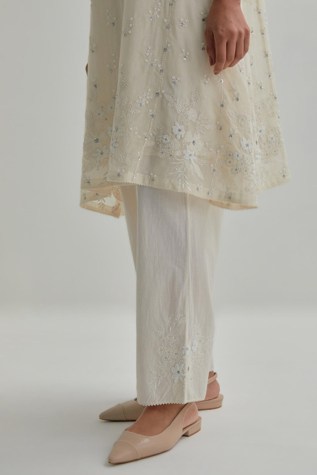 Off white cotton Chanderi short kalidar kurta set with all-over appliqué flowers, highlighted with sequins and beads.
