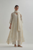 Off-white cotton Chanderi kurta set with asymmetric hem and all-over appliqué flowers, highlighted with sequins and beads.