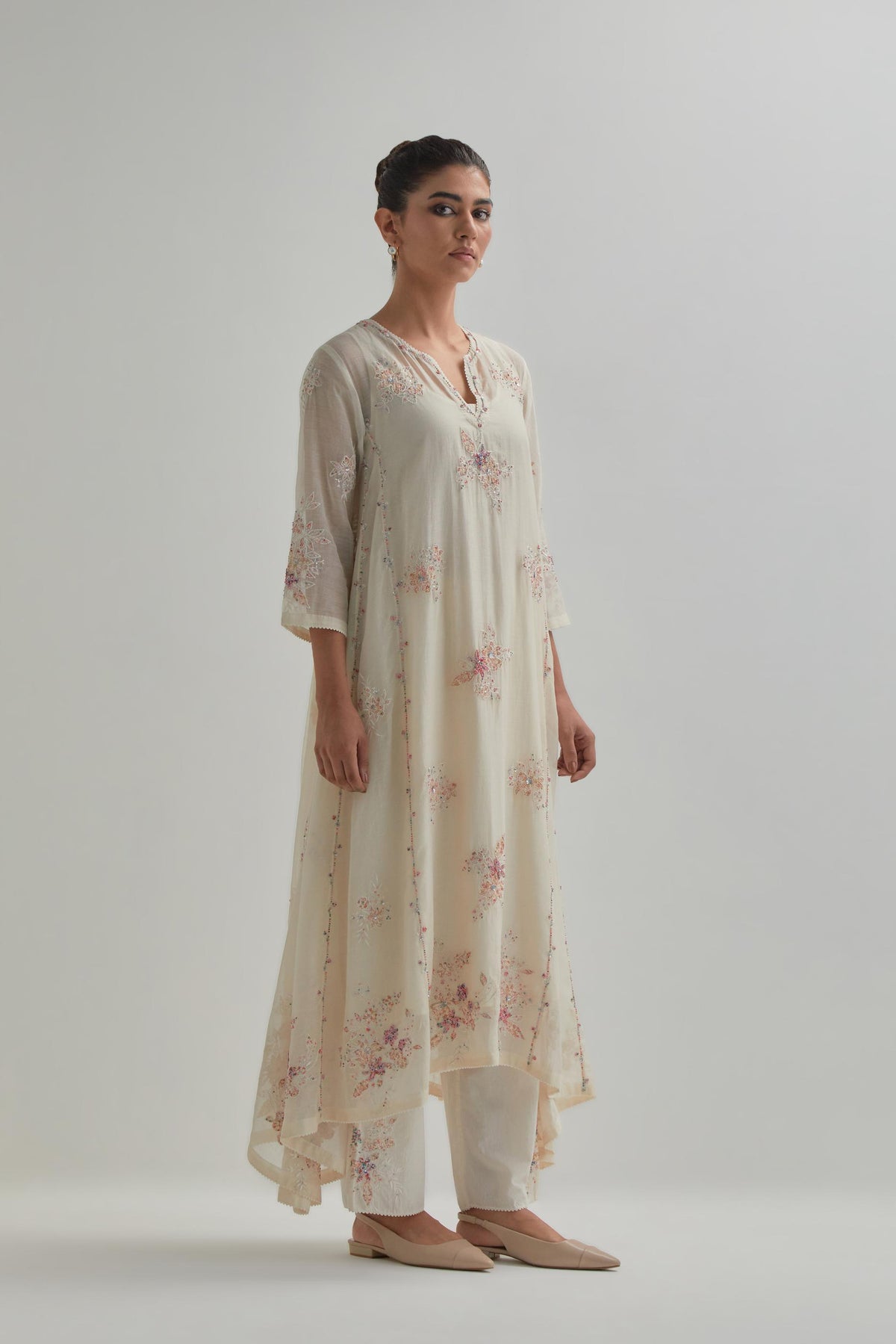 Off-white cotton Chanderi kurta set with asymmetric hem and all-over pink & beige hand block printed appliqué flowers.