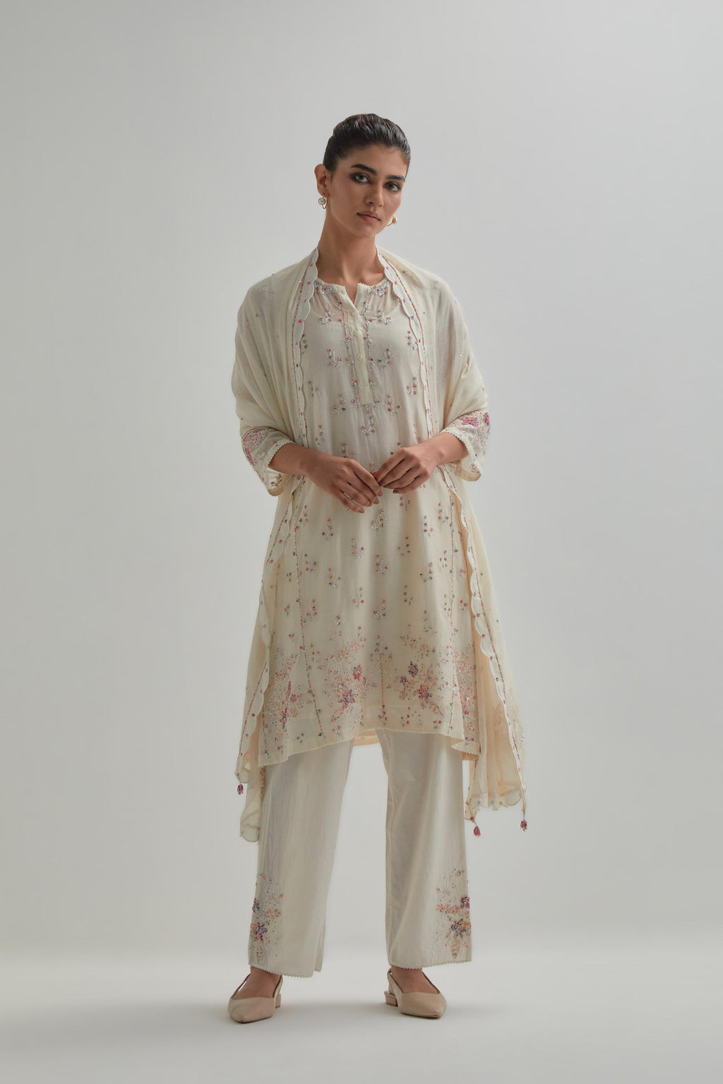 Off white cotton Chanderi short kalidar kurta set with all-over pink & beige hand block printed appliqué flowers, highlighted with sequins and multi coloured beads.