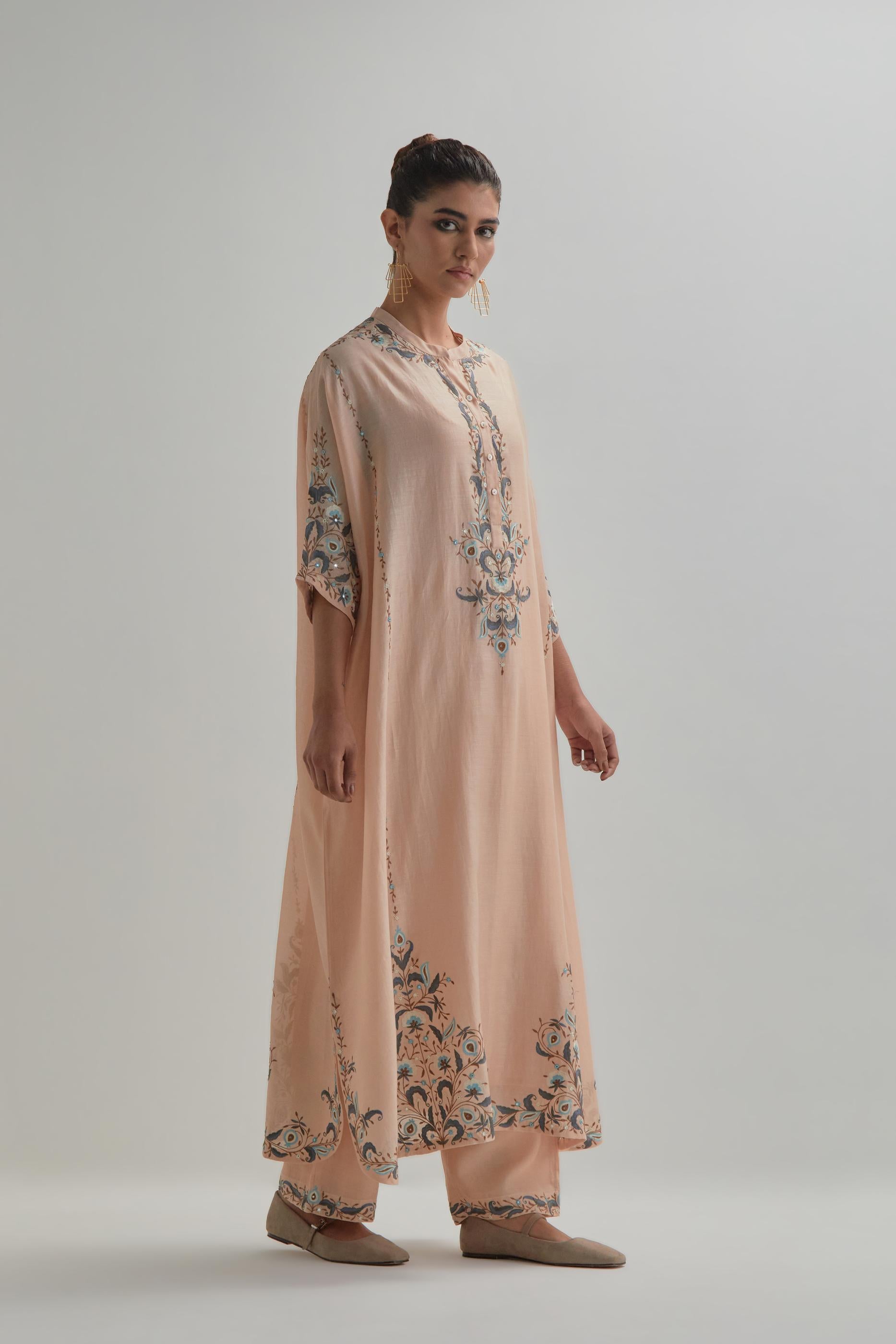 Pink Silk Chanderi easy fit kaftan with earthy coloured thread Aari embroidery, highlighted with silver sequins work, paired with Pink silk Chanderi straight pants with earthy coloured Aari work at hem.