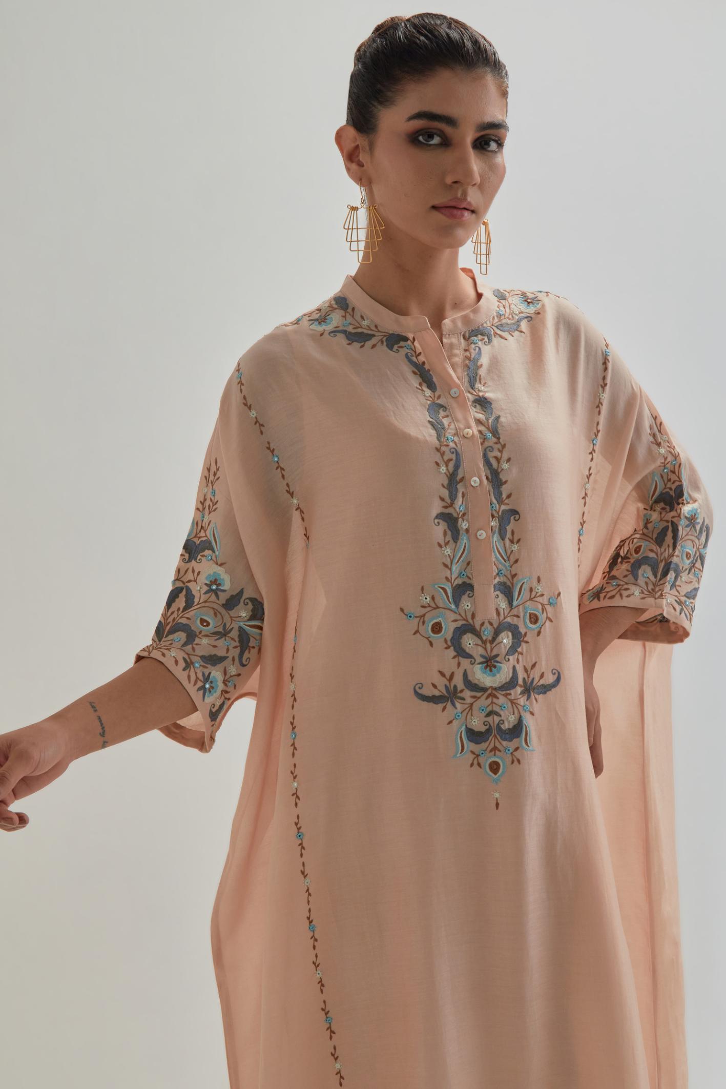 Pink Silk Chanderi easy fit kaftan with earthy coloured thread Aari embroidery, highlighted with silver sequins work, paired with Pink silk Chanderi straight pants with earthy coloured Aari work at hem.