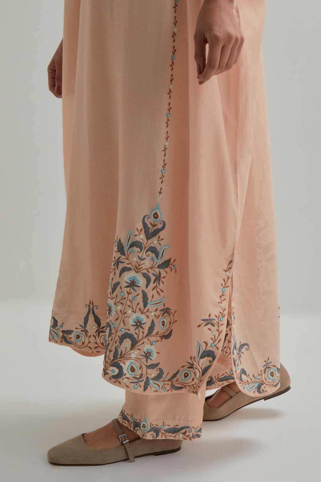Pink Silk Chanderi easy fit kaftan with earthy coloured thread Aari embroidery, highlighted with silver sequins work, paired with Pink silk Chanderi straight pants with earthy coloured Aari work at hem.