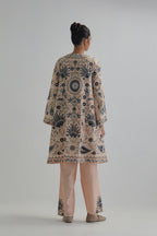 Pink short front open A-line jacket, fully embroidered with bold appliqué flowers, earthy-coloured Aari thread work and silk tassels, paired with Pink silk Chanderi straight pants with earthy coloured appliqué at hem.