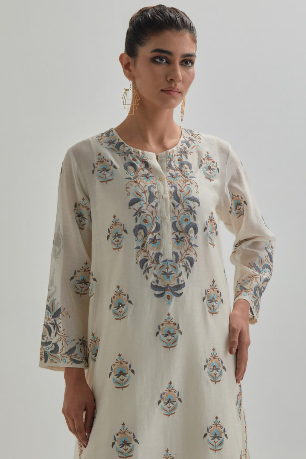 Off White silk Chanderi short kurta set with all-over floral boota embroidery, highlighted with silver sequins.