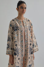Pink short front open A-line jacket, fully embroidered with bold appliqué flowers, earthy-coloured Aari thread work and silk tassels, paired with Pink silk Chanderi straight pants with earthy coloured appliqué at hem.