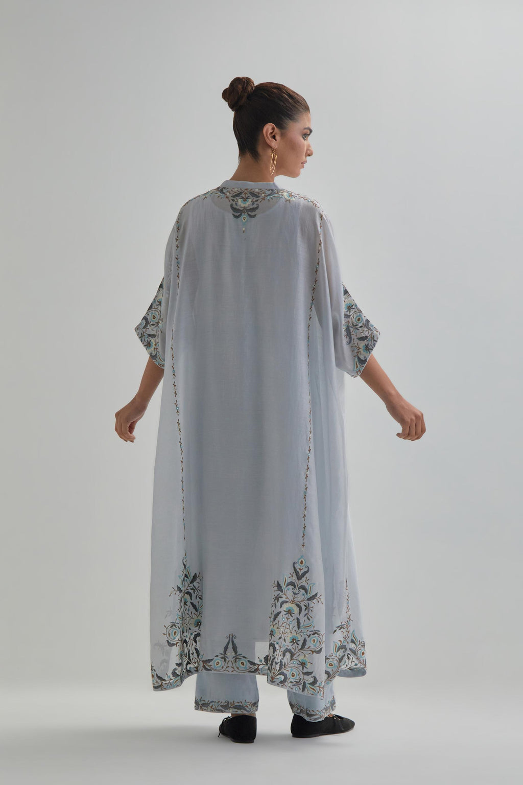 Blue Silk Chanderi easy fit kaftan with earthy coloured thread Aari embroidery, highlighted with silver sequins work, paired with Blue silk Chanderi straight pants with earthy coloured Aari work at hem.