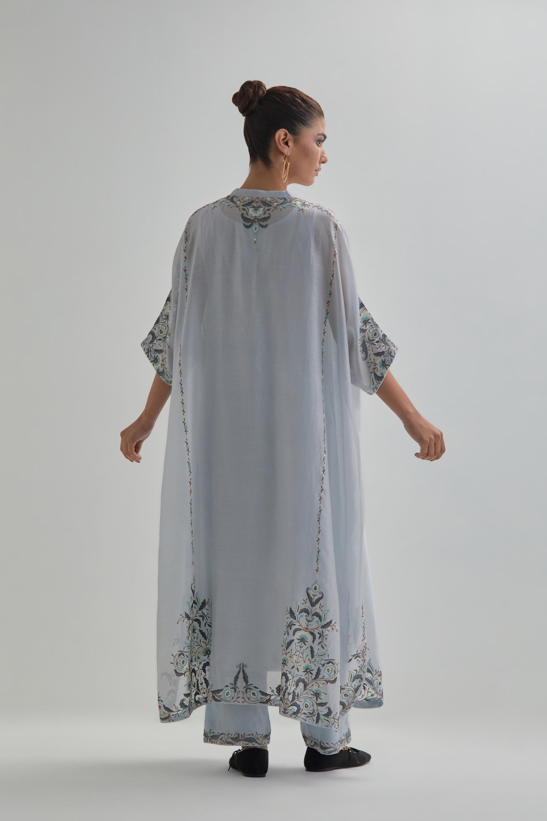 Blue Silk Chanderi easy fit kaftan with earthy coloured thread Aari embroidery, highlighted with silver sequins work, paired with Blue silk Chanderi straight pants with earthy coloured Aari work at hem.