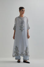 Blue Silk Chanderi easy fit kaftan with earthy coloured thread Aari embroidery, highlighted with silver sequins work, paired with Blue silk Chanderi straight pants with earthy coloured Aari work at hem.
