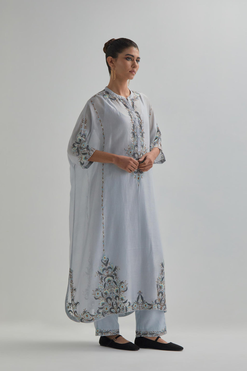 Blue Silk Chanderi easy fit kaftan with earthy coloured thread Aari embroidery, highlighted with silver sequins work, paired with Blue silk Chanderi straight pants with earthy coloured Aari work at hem.