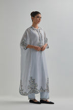 Blue Silk Chanderi easy fit kaftan with earthy coloured thread Aari embroidery, highlighted with silver sequins work, paired with Blue silk Chanderi straight pants with earthy coloured Aari work at hem.