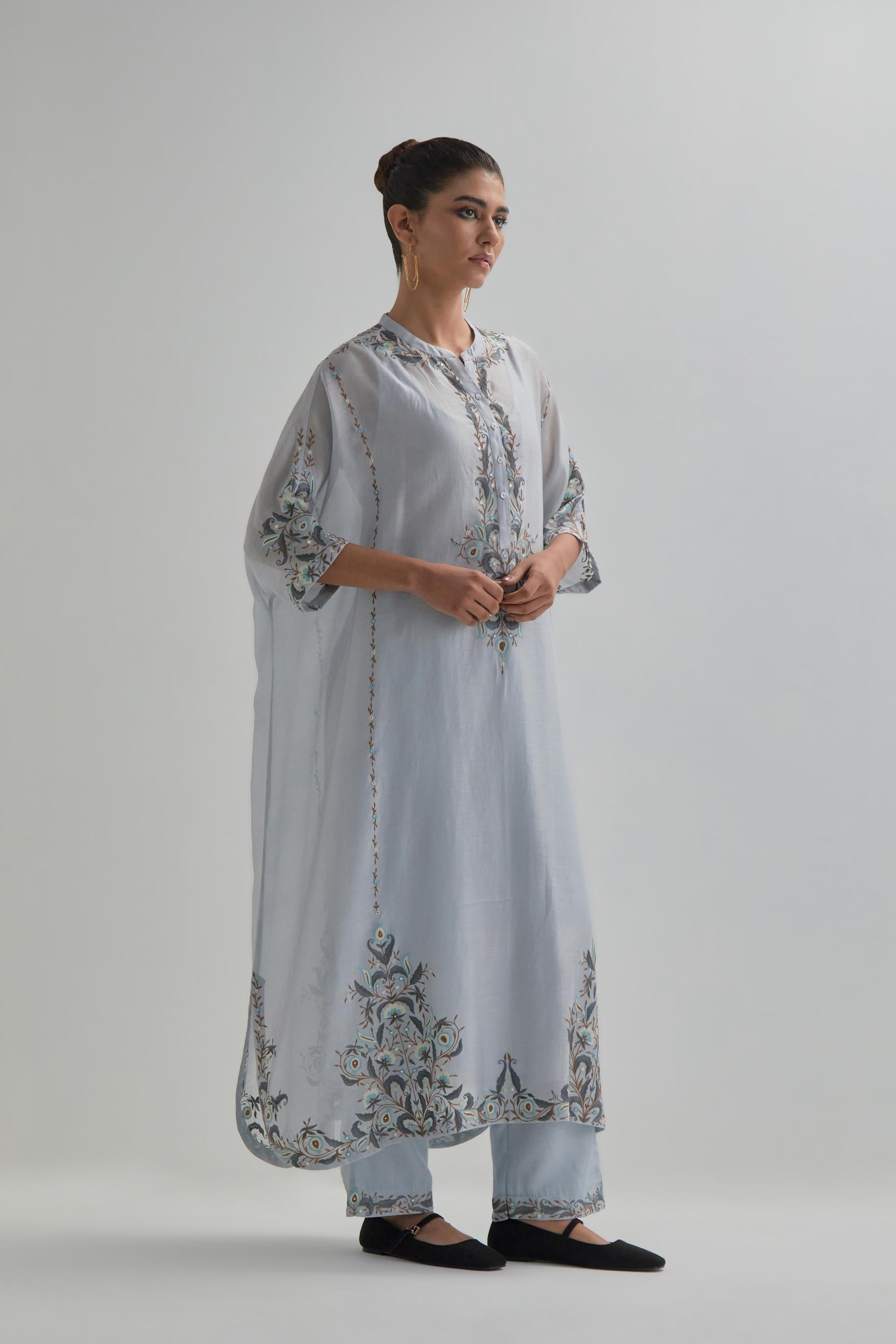 Blue Silk Chanderi easy fit kaftan with earthy coloured thread Aari embroidery, highlighted with silver sequins work, paired with Blue silk Chanderi straight pants with earthy coloured Aari work at hem.