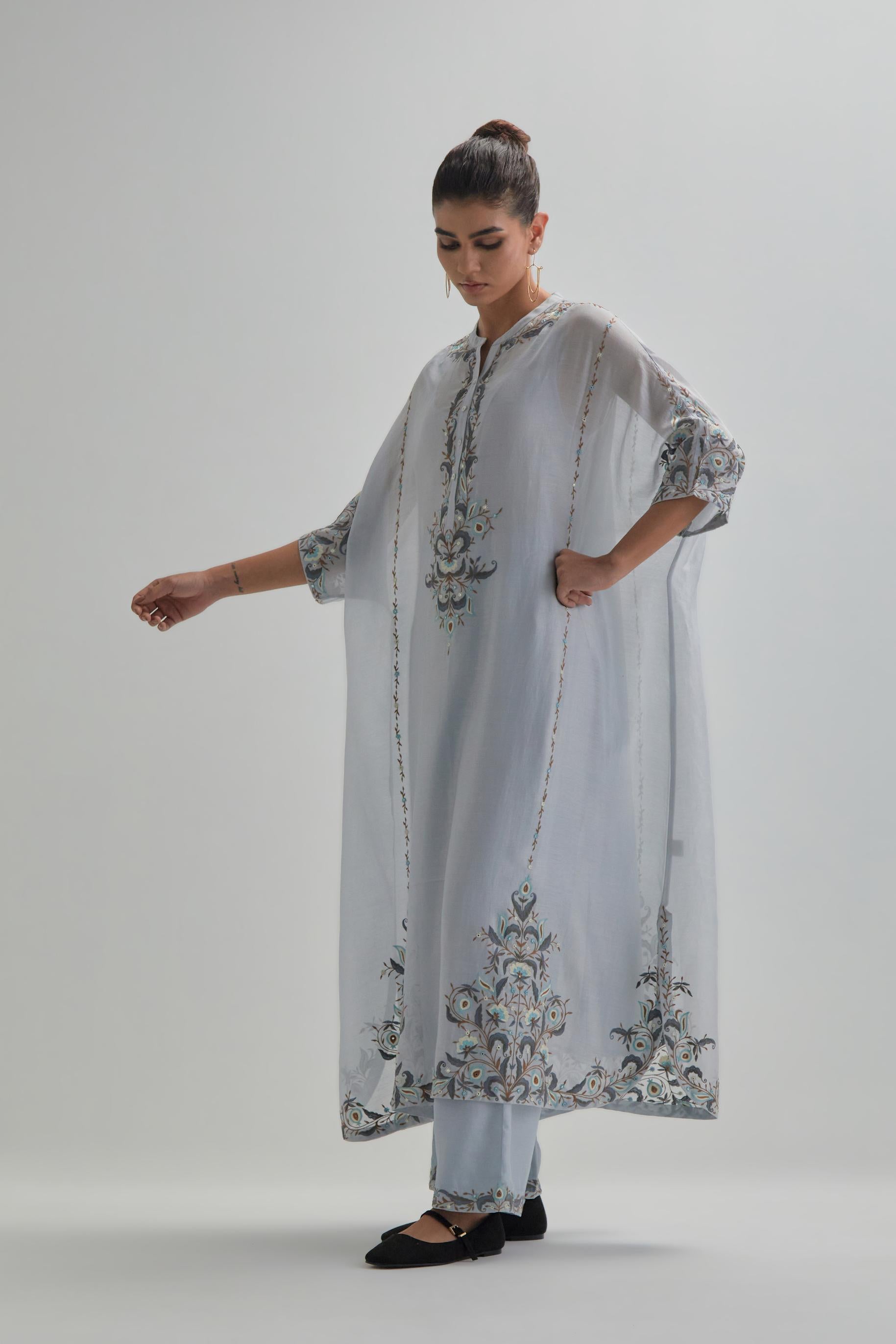 Blue Silk Chanderi easy fit kaftan with earthy coloured thread Aari embroidery, highlighted with silver sequins work, paired with Blue silk Chanderi straight pants with earthy coloured Aari work at hem.