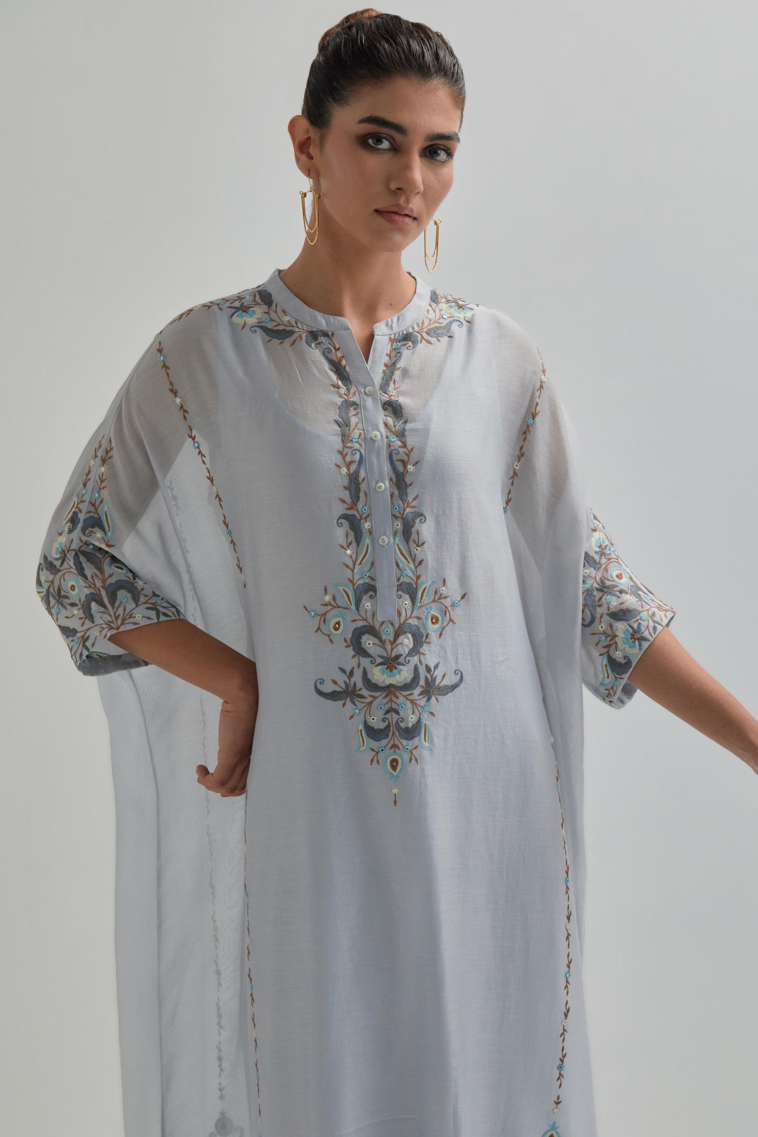 Blue Silk Chanderi easy fit kaftan with earthy coloured thread Aari embroidery, highlighted with silver sequins work, paired with Blue silk Chanderi straight pants with earthy coloured Aari work at hem.