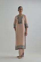 Pink slim fit straight kurta set, decorated with bold appliqué borders all along the side seam, hem and sleeve cuffs.