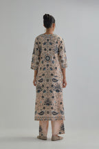 Pink straight kurta set, fully embroidered with bold appliqué flowers, earthy-coloured Aari thread work and silk tassels.
