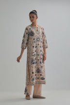Pink straight kurta set, fully embroidered with bold appliqué flowers, earthy-coloured Aari thread work and silk tassels.