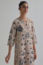 Pink straight kurta set, fully embroidered with bold appliqué flowers, earthy-coloured Aari thread work and silk tassels.