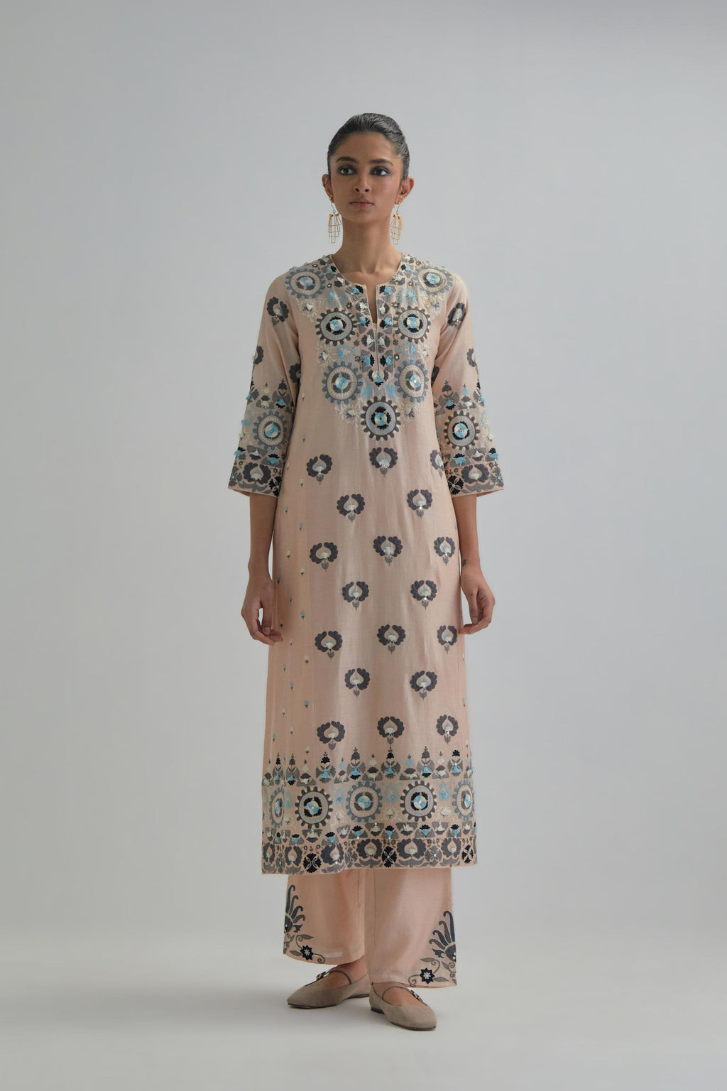 Pink straight kurta, fully embroidered with appliqué flowers, earthy-coloured Aari thread work and silk tassels.
