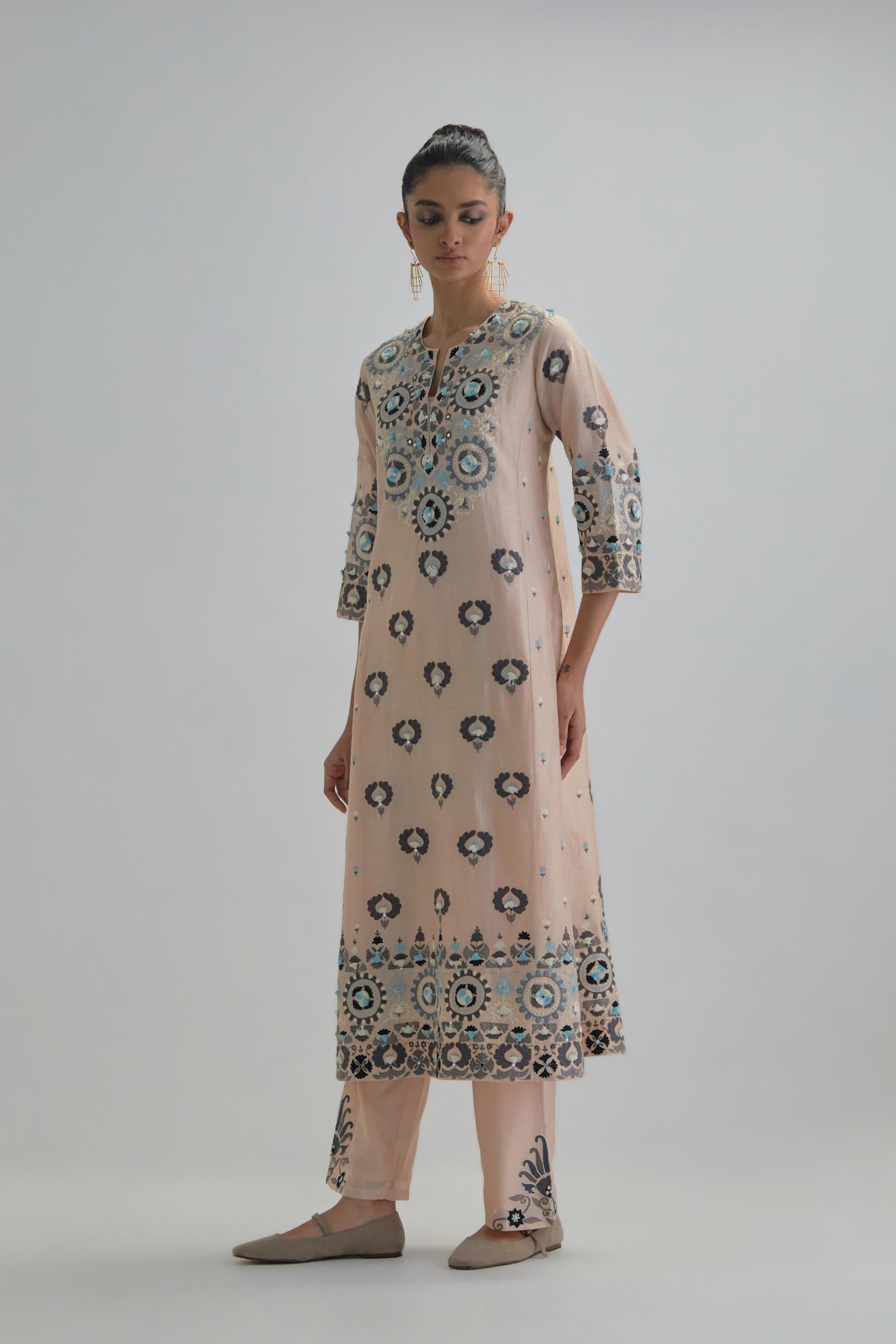 Pink straight kurta, fully embroidered with appliqué flowers, earthy-coloured Aari thread work and silk tassels.