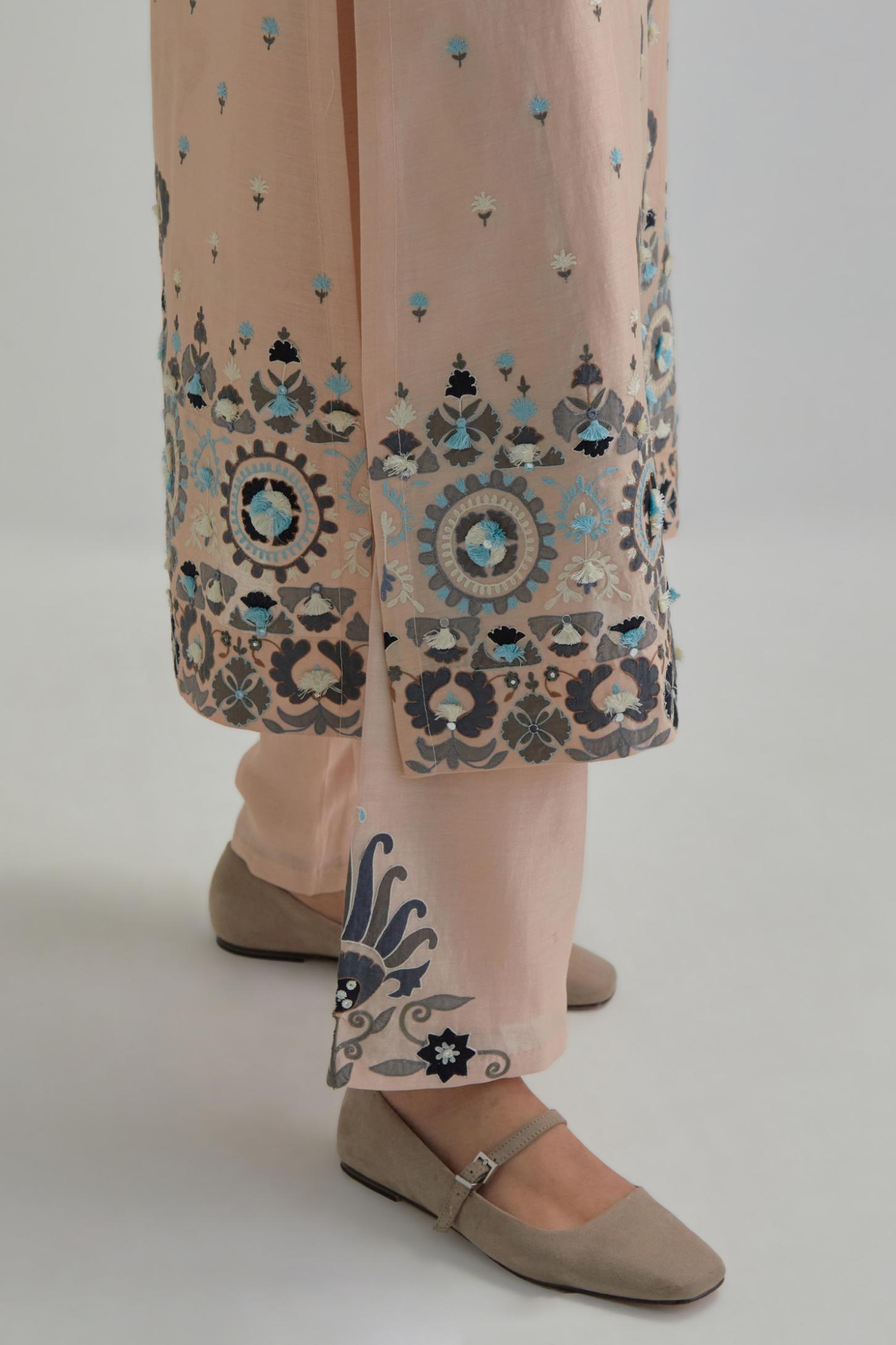 Pink straight kurta, fully embroidered with appliqué flowers, earthy-coloured Aari thread work and silk tassels.