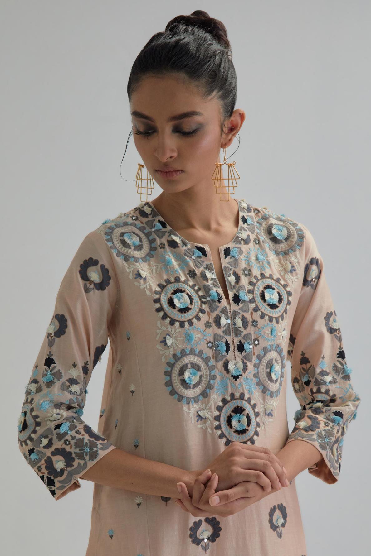 Pink straight kurta, fully embroidered with appliqué flowers, earthy-coloured Aari thread work and silk tassels.