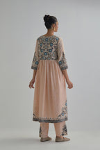 Pink silk Chanderi kurta-dress set with a wavy high-waist and fine gathers. The yoke is fully embroidered with earthy coloured circular appliqué and Aari thread work.