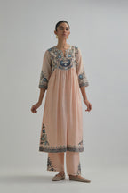 Pink silk Chanderi kurta-dress set with a wavy high-waist and fine gathers. The yoke is fully embroidered with earthy coloured circular appliqué and Aari thread work.