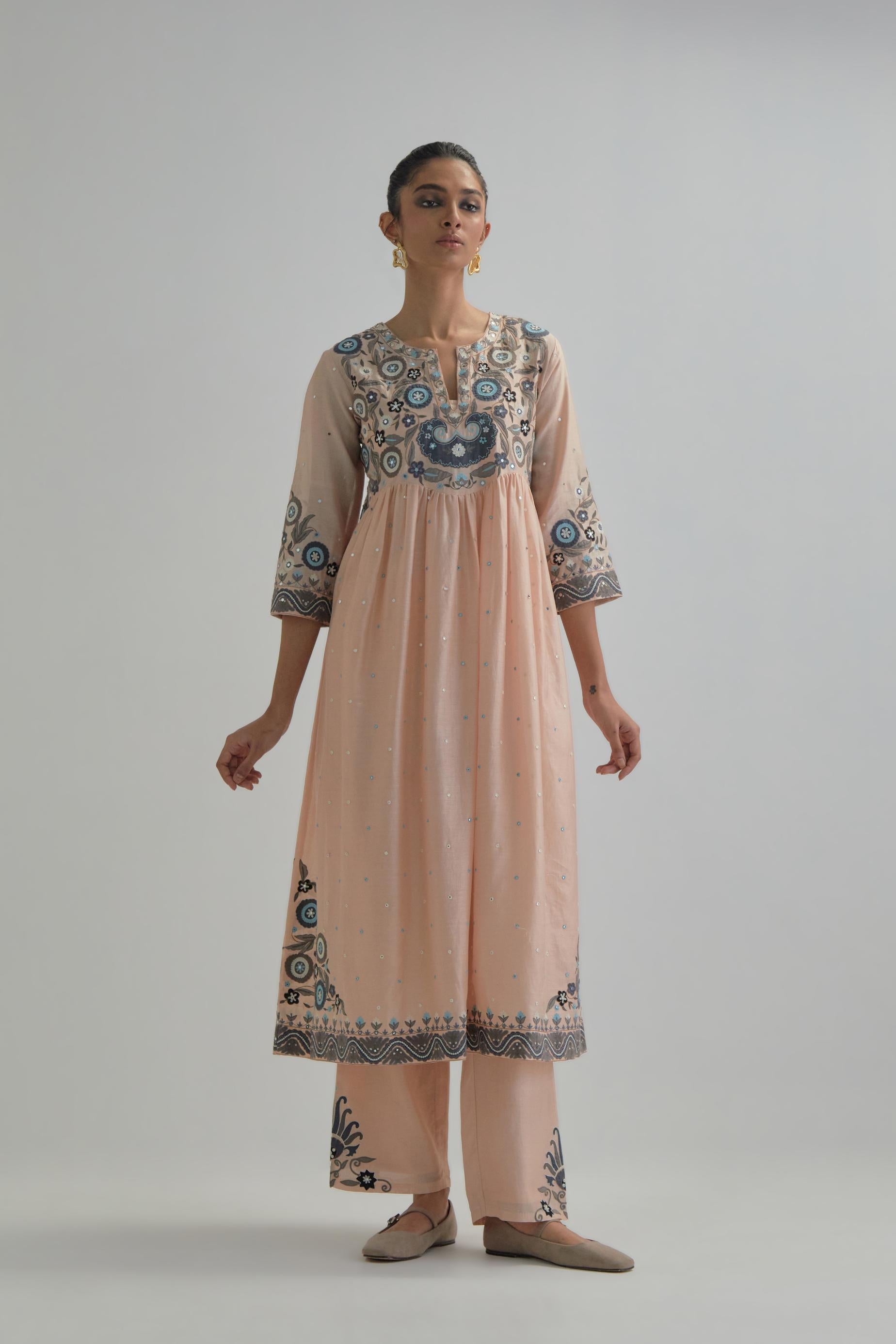 Pink silk Chanderi kurta-dress set with a wavy high-waist and fine gathers. The yoke is fully embroidered with earthy coloured circular appliqué and Aari thread work.