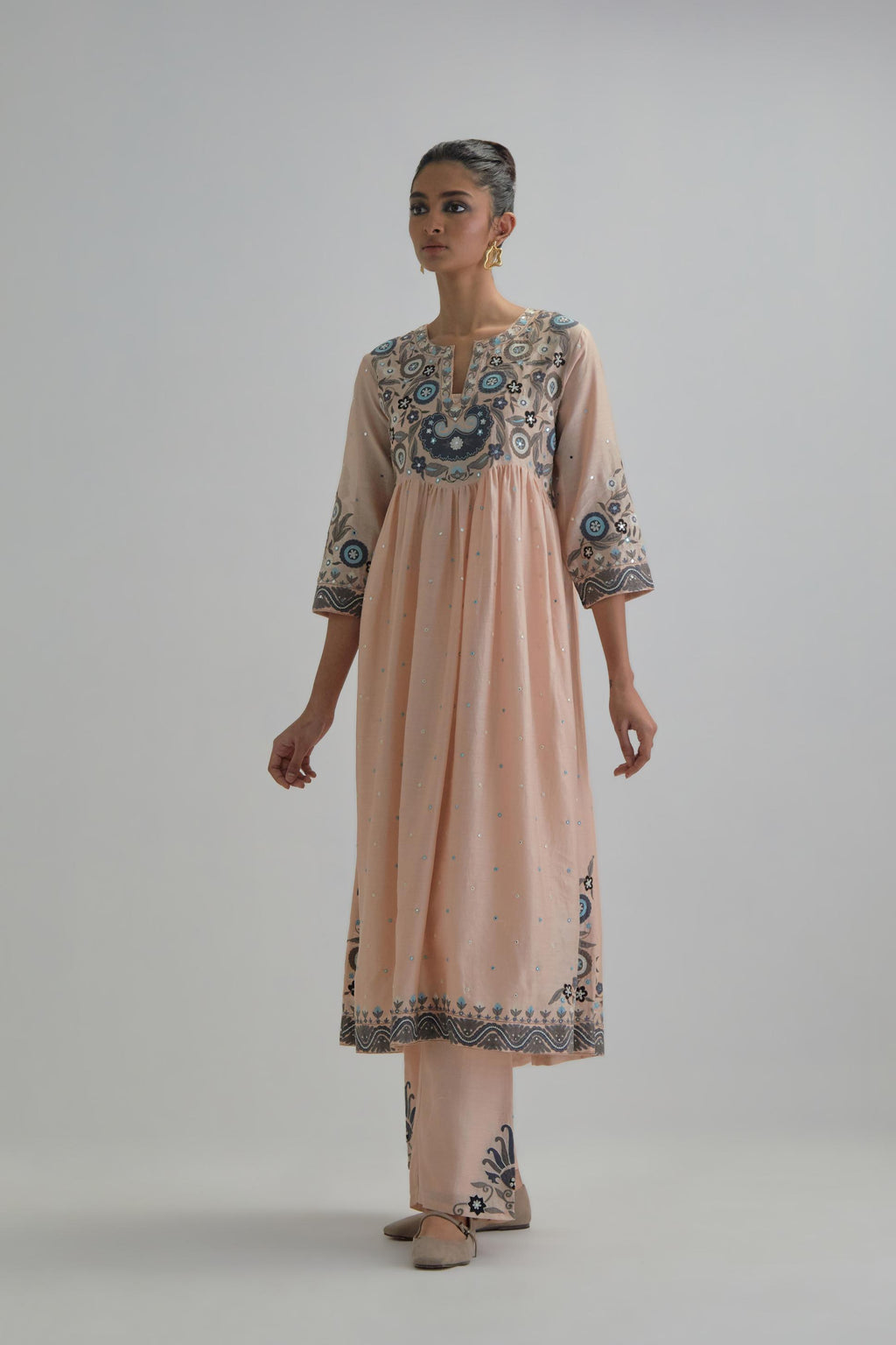 Pink silk Chanderi kurta-dress set with a wavy high-waist and fine gathers. The yoke is fully embroidered with earthy coloured circular appliqué and Aari thread work.